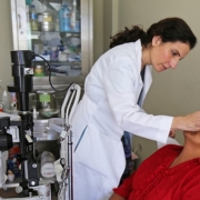 Dr. Mosaed putting eye drops on a patient